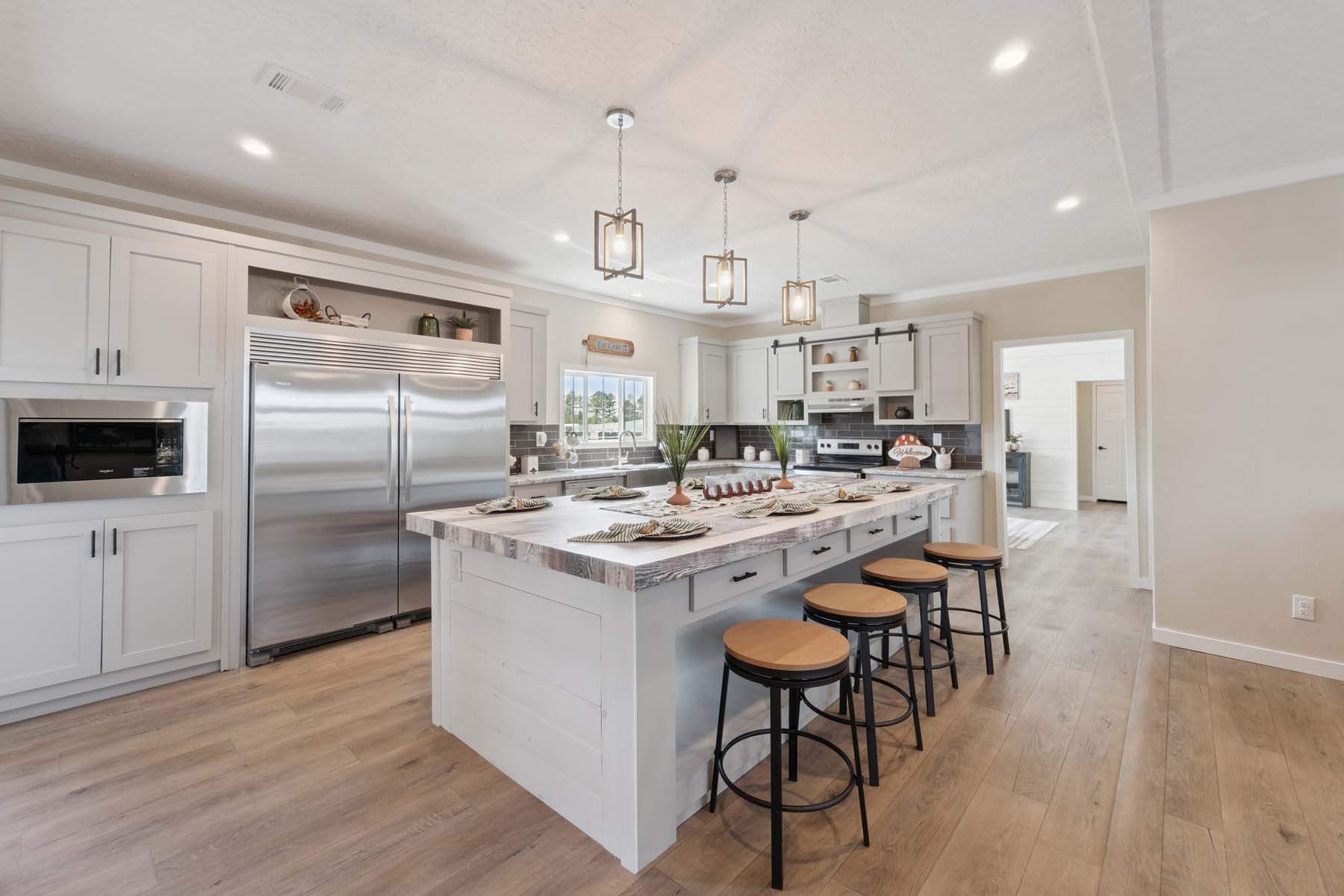Kitchen view showing the stainless steel refrigerator and pantry area in The Commander.